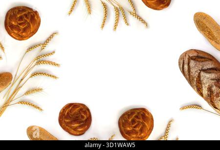 Assorted different fresh baked bread, dark and white whole grain loaves, wheat ears on a white background with space for text. Top view, flat lay Stock Photo