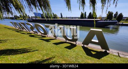 Autostadt sign on the Mittelland Canal with a barge passing by, Wolfsburg, Germany, Europe Stock Photo
