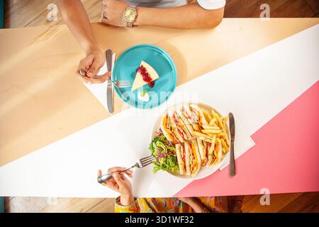 Male and Female friends enjoying having club in a restaurant cafe. Stock Photo