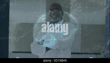 Standing senior doctor in lab coat projecting holographic brain in hall with stethoscope, overlay Stock Photo