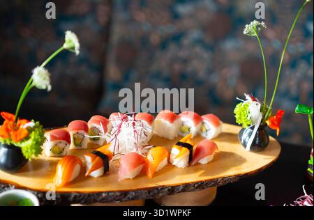 Sushi Nigiri and Rolls on Wooden Platter Stock Photo