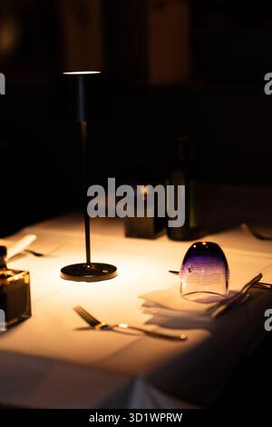 Blue Glass Upside Down on White Tablecloth Stock Photo
