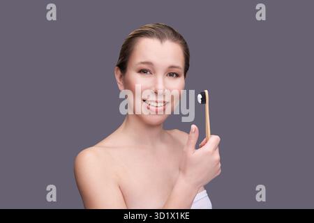Girl hold toothbrush with toothpaste. Oral home routine Stock Photo