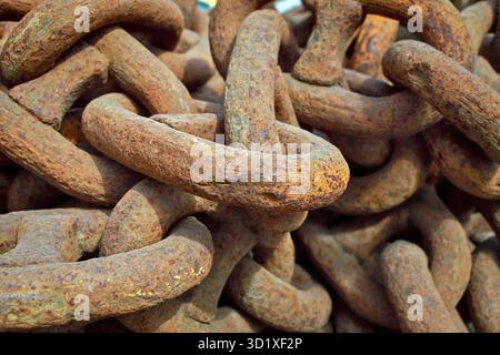 Heavy rusty industrial chains in storage yard. Stock Photo