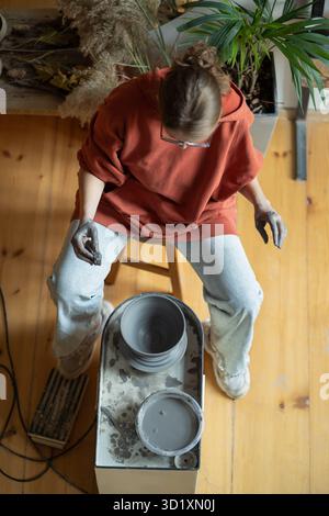 Working on potters wheel with raw clay for reboot from job relieve worry stress, get inspiration. Stock Photo
