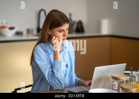 Workaholic. Beautiful young focused business woman freelancer working on laptop, very early work Stock Photo