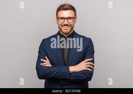 Happy successful confident businessman in suit with crossed arms on chest smiling looking at camera Stock Photo