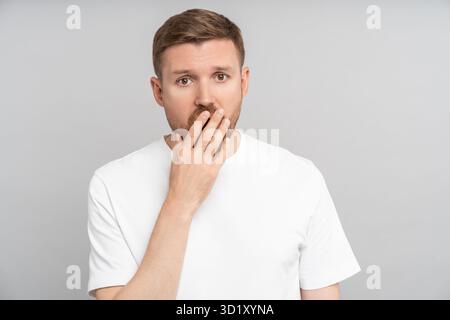 Sleepy middle-aged man yawning of tiredness, overworking, chronic fatigue, restless night, insomnia Stock Photo