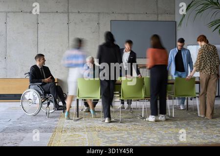 A diverse business team, working urgently around a conference table, collaborates on a meeting while their director, seated in a Stock Photo
