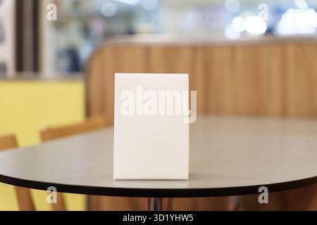 Menu mock up blank for text marketing promotion. Mock up Menu frame standing on wood table in restaurant space for text Stock Photo