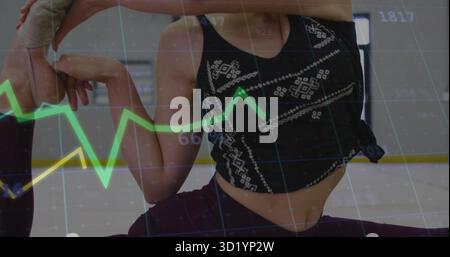 Bending left knee behind head, teen dancer performing stretch in studio, with barre, graph overlay Stock Photo