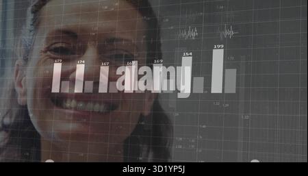 Displaying smiling woman's face on office dashboard with bar chart line graph and number overlays Stock Photo