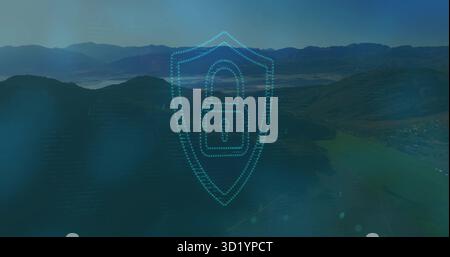 Transparent dotted-line shield graphic hovering over misty mountain valley, with padlock icon Stock Photo