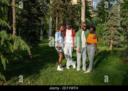 Young multiracial group of friends travel together, stand and posing for camera in park woods Stock Photo