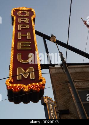 Vintage Orpheum Theater neon sign surrounded by lightbulbs. Photographed from below in Memphis, Tennessee, at dusk. Stock Photo