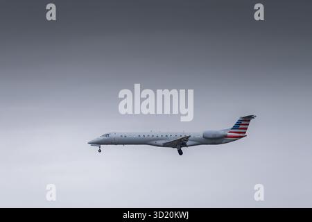 Airliner aircraft approaching airport with a dark moody sky Stock Photo
