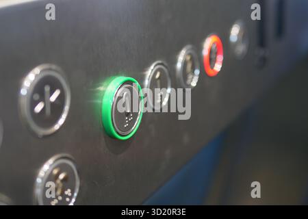 Illuminated elevator control panel in a building Stock Photo