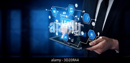 A business professional interacts with a tablet displaying lean management concepts. Focused on improving efficiency, waste reduction, and organizatio Stock Photo