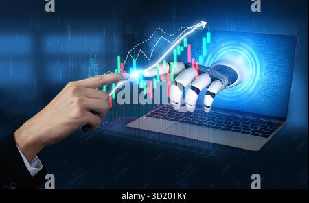 A close-up view of a robotic hand interacting with a laptop screen displaying stock market graphs and digital data, symbolizing financial technology a Stock Photo