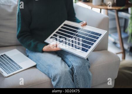 Home owner install solar power systems in her house Asian Woman learning about sustainable technology Stock Photo
