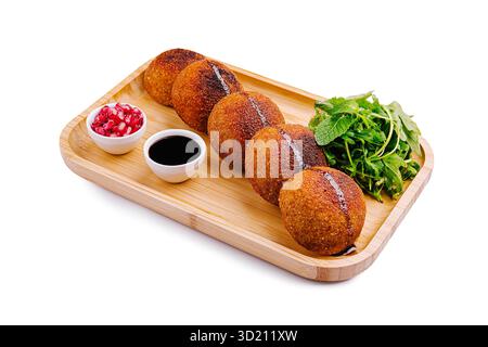 Deliciously crispy snack served on a wooden platter with fresh herbs and dips Stock Photo