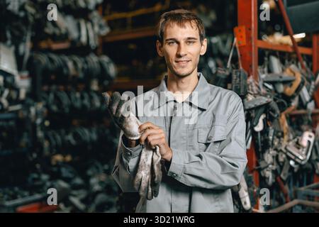 portrait young Caucasian technician worker working in heavy industry, looking camera happy smiling Stock Photo