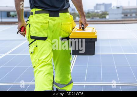 Professional Engineer Service Solar Panel. Worker Maintenance Cleaning Replacing Solar Panel. Solar photovoltaic panel system in Industry roof. Saving Stock Photo