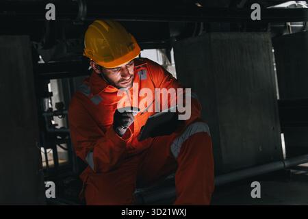 Professional engineer hispanic latin male service leakage check maintenance underground valve pipeline using tablet digital device technology Stock Photo