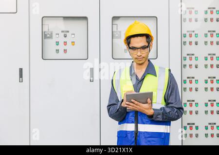 Professional Electrician Engineer man working check service maintenance electricity main circuit fuse switch cabinet power system in industry factory Stock Photo