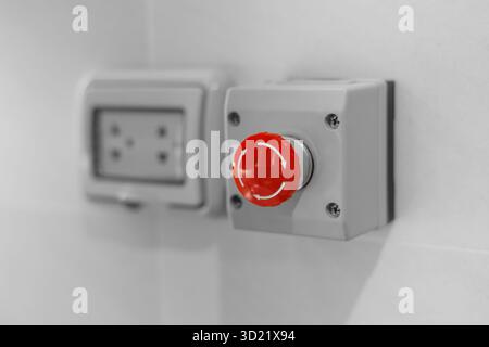 red emergency stop button, stop breaker pressing switch, urgent calling for help, stop loss push button concept. Stock Photo