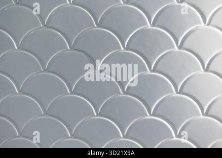 White tile in fish scale, cloud, wave style in toilet wall texture pattern mosaic light shade for background Stock Photo