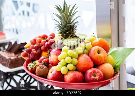 Bowl of fresh fruit with banana, apple, strawberries, apricots, blueberries, plums. top view Stock Photo