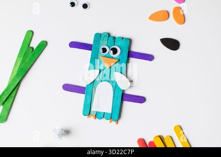 Children's funny craft made of wooden sticks and paper in the form of a bird. Children's creativity Stock Photo
