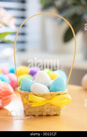 Colorful plastic eggs with candies inside in a basket. Egg hunt. Happy Easter Stock Photo