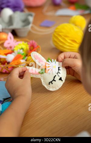 Easter crafting activity with felt bunny and colorful decorations for kids. Easter. DIY Stock Photo
