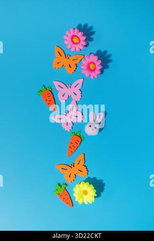 Colorful easter and spring decorations with butterflies, flowers and bunny on blue Stock Photo