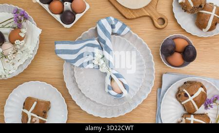 Easter egg wrapped in linen napkin in the shape of bunny with ears. Happy Easter Stock Photo