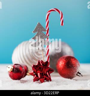Christmas decor with candy cane and ball baubles on artificial snow Stock Photo