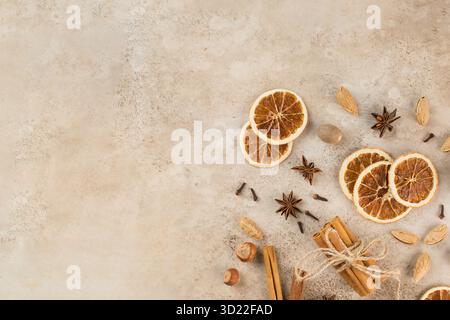 Cinnamon sticks, slices of dried orange, star anise. Top view. Autumn background. The concept of celebrating Christmas. Stock Photo