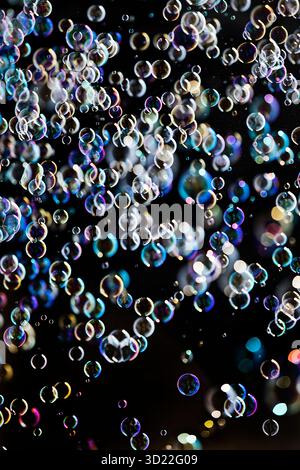 Many small shimmering and floating soap bubbles against black background, Recklinghausen, North Rhine-Westphalia, Germany, Europ Stock Photo