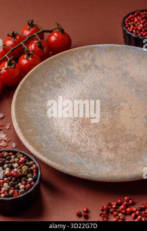 Empty round black plate for food, kitchen utensils on dining table. Empty plate Stock Photo