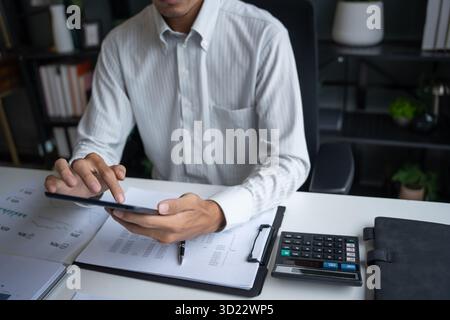 Male Professional Working on Digital Tablet in Office Stock Photo