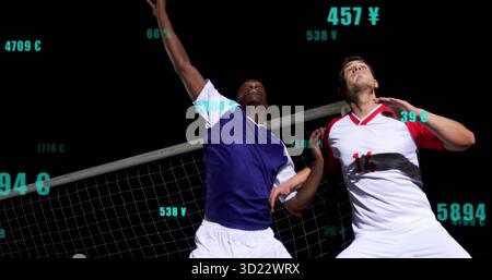 Two soccer players in jerseys jumping for header on night field near goal net, numeric overlays Stock Photo