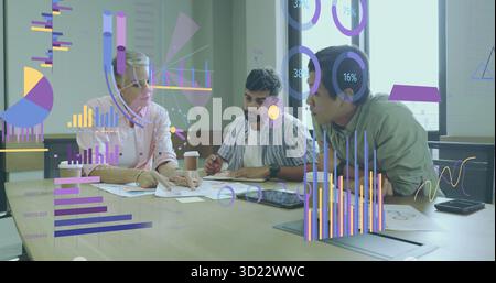 Collaborating three colleagues analyzing data overlays with charts at meeting table, with tablet Stock Photo