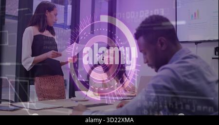 Collaborating staff in formal attire at conference table, with printouts, laptop, digital overlay Stock Photo
