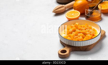 Fresh orange dessert with mango cubes on wooden board Stock Photo