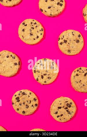 Fresh cookies with chocolate chips on a pink background. Dessert, a pastry shop. Pattern. Stock Photo