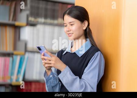 Asian woman chats with AI on mobile to enhance knowledge Stock Photo