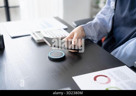 Woman charging smartphone by using magnetic wireless charger Stock Photo