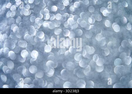 Abstract silver bokeh background with defocused circular light patterns creating Stock Photo